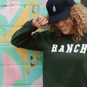 woman in hidden valley cap and sweatshirt that says Ranch